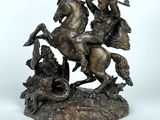 bronze statue of a man on a horse with a man on a horse