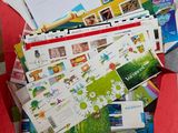 a red box filled with lots of postcards and envelopes