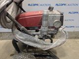 an image of a lawn mower with a hose attached to it