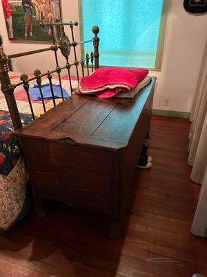 a bed with a wooden headboard and foot board in a room