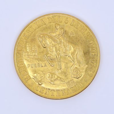 a gold coin with a picture of a man on a horse