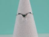 a close up of a ring on top of a white cone