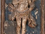 a statue of a man holding a child on a cross