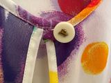 a close up of a dress with a button on it