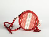 a red round purse with a tassel on a white background