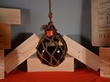 a bottle of wine that is hanging from a rope