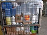a metal cart filled with bottles and containers in a warehouse