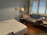a bedroom with a bed and a desk in it