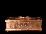 a gold box that is sitting on a black surface