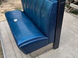 a blue bench that is sitting on the ground