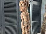 three wooden sculptures that are on display in a room