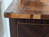 a close up of a wooden desk with a clock on it