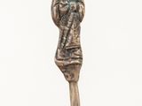 a statue of a woman holding a baby on top of a stick