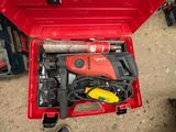 a red tool box with tools in it on the ground
