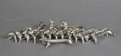 a lot of silver figurines sitting on top of a table