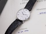 a watch sitting on top of a piece of paper