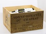 bottles of wine in a wooden crate on a white surface