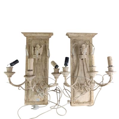 pair of carved wood sconces with candles and a remote control