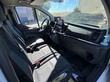 the interior of a white van with black seats and a steering wheel