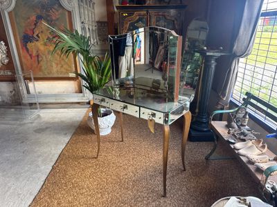 a glass table with a mirror on it in a room