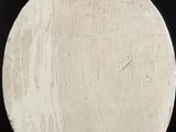 a white plate that has a green button on it