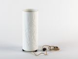 a white vase that has a rope on it