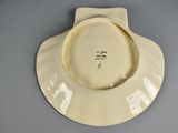 cream colored porcelain bowl with a white rim and a black inscription on the side