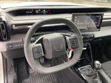the interior of a car with a steering wheel and dashboard controls