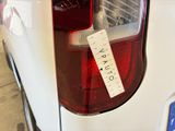 a sticker on the tail light of a white car