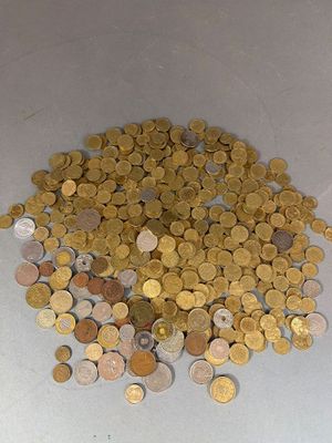 a pile of coins sitting on a white surface