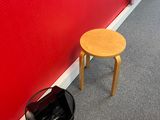 a small table and a trash can in the corner of a room