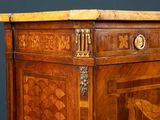 a wooden cabinet with a marble top on a table