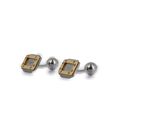 pair of silver and gold cufflinks on a white background