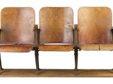three wooden seats that are sitting on a wooden stand