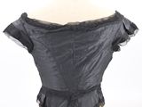 black leather corset top with ruffles on a mannequin dummy