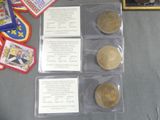 several coins are sitting on top of a table next to other items