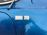 a close up of a blue car with a number plate on it