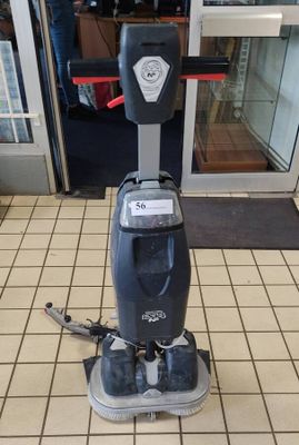 a machine that is sitting on the floor in front of a store