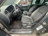 the interior of a car with the door open and the driver ' s seat down