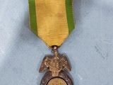 an image of a medal with an eagle on it on a blue surface