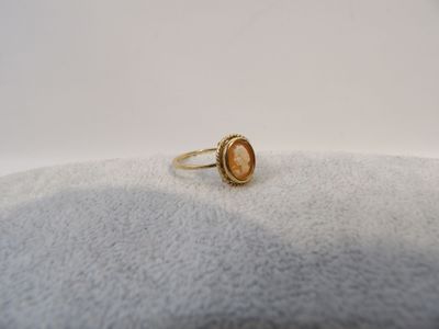 a close up of a gold ring on a white surface