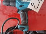 a corded drill sitting on top of a red box