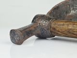 an old hammer with a wooden handle on a white surface
