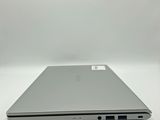 an open laptop computer sitting on top of a white surface