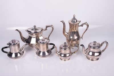 silver plated tea and coffee set on a white surface