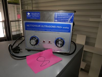 a pink piece of paper sitting on top of a machine