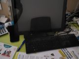 an image of a computer monitor and keyboard on a desk