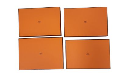 four orange boxes are stacked on top of each other on a white surface