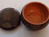 a small bowl with a lid sitting on a table