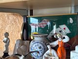 many figurines sitting on a shelf in a room